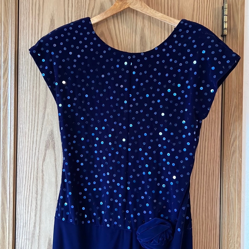 Velvet party dress with cap sleeves, sequins and decorative rose at waist.